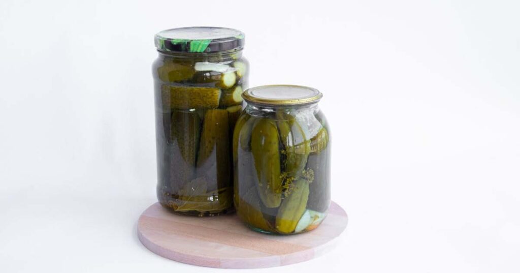 Sour pickles at home with vinegar in jar